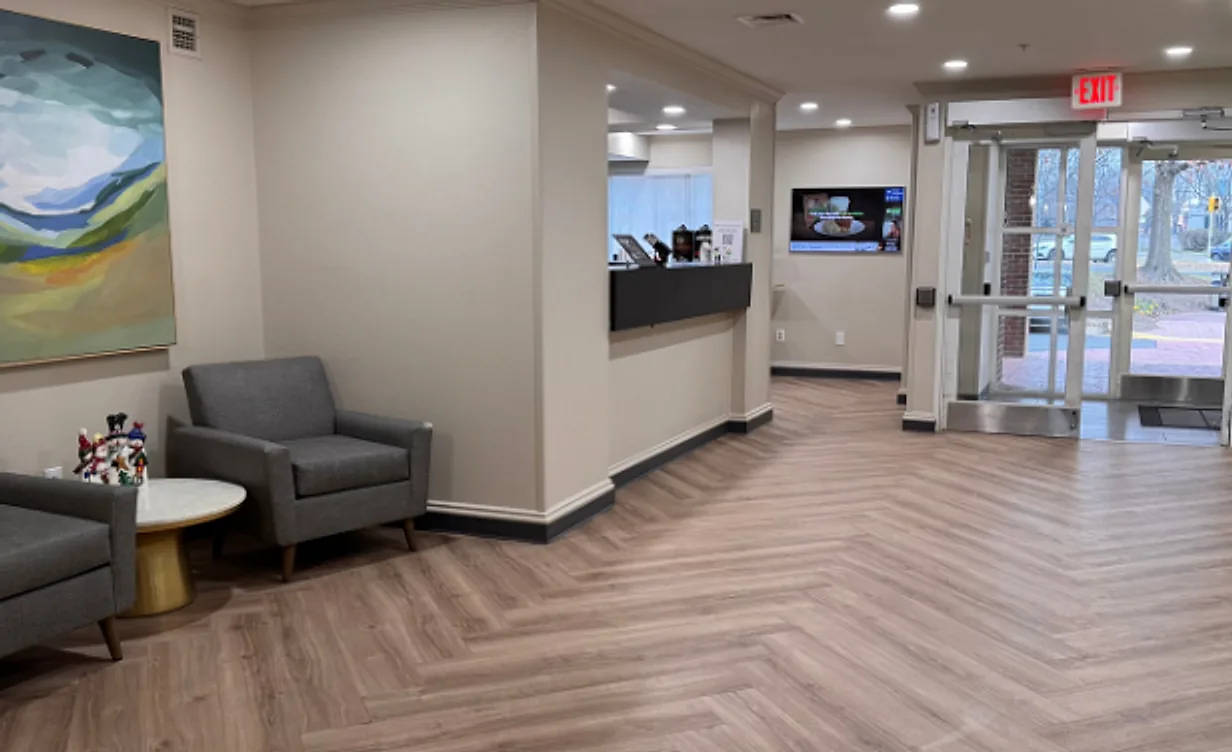 Hotel lobby after the renovation: herringbone vinyl plank flooring