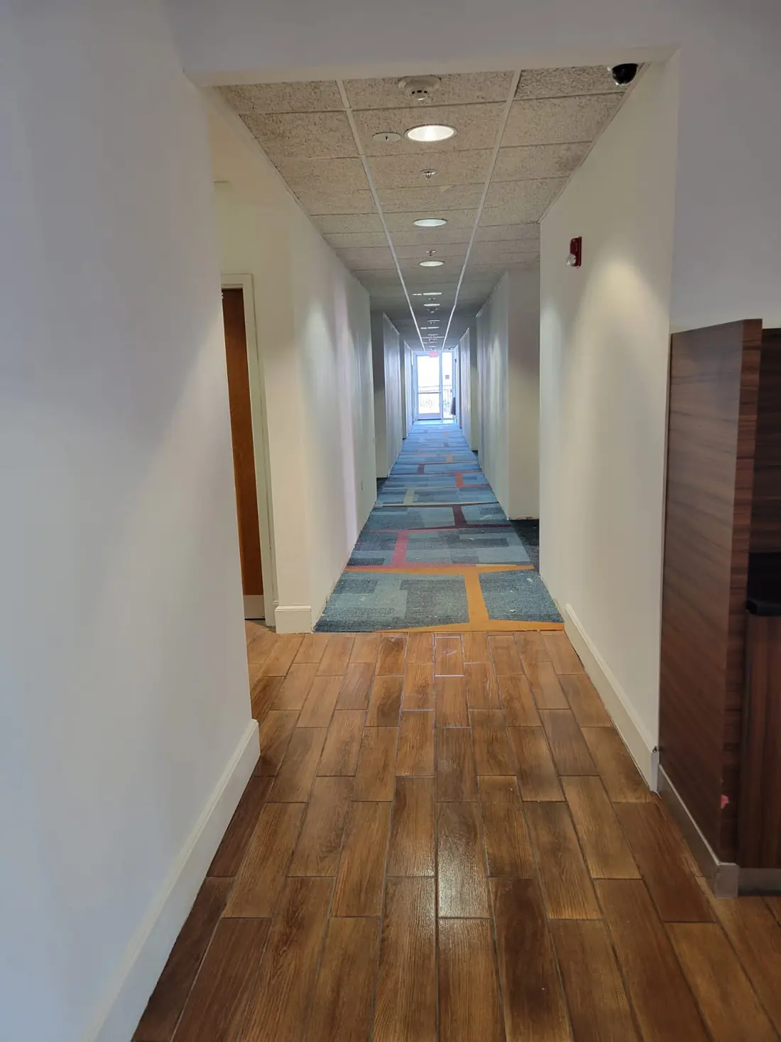 Renovated corridor with new flooring and ceiling