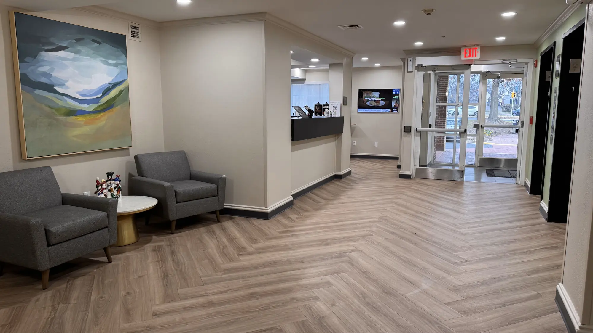 Renovated hotel lobby with herringbone luxury vinyl plank flooring